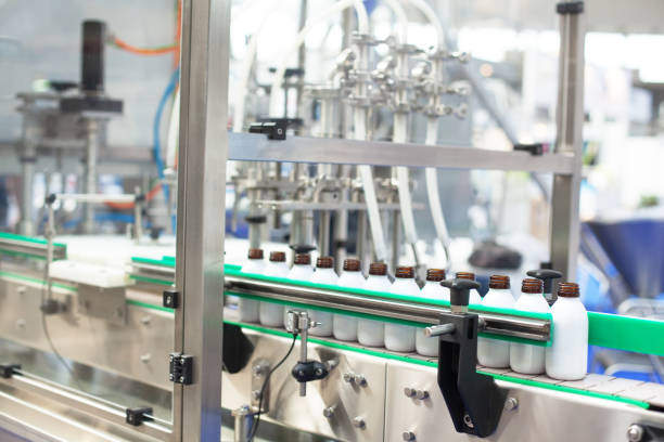 istock Automated assembly line for bottling and packaging liquid products in a modern industrial facility 2196006028