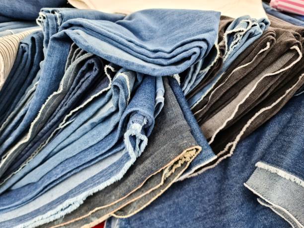 istock Stack of Folded Denim Jeans Showing Various Colors and Textures 2196008438