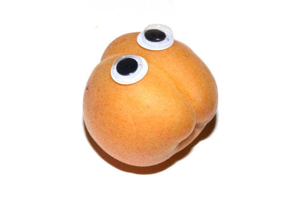 Close up of a fresh apricot fruit with Boggle Eyes Silly