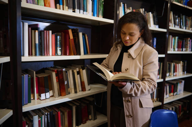 istock Woman reading a book in a library during World Book Day event 2196010779