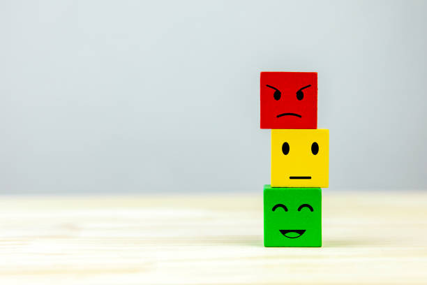 istock Stacked wooden cubes with emoticon faces according to color scale. 2196011332