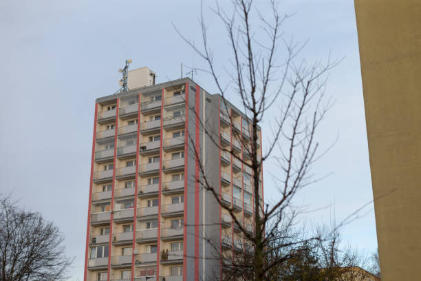 istock A Residential Building Stands Against a Gloomy Sky Surrounded by a Tree 2196011432