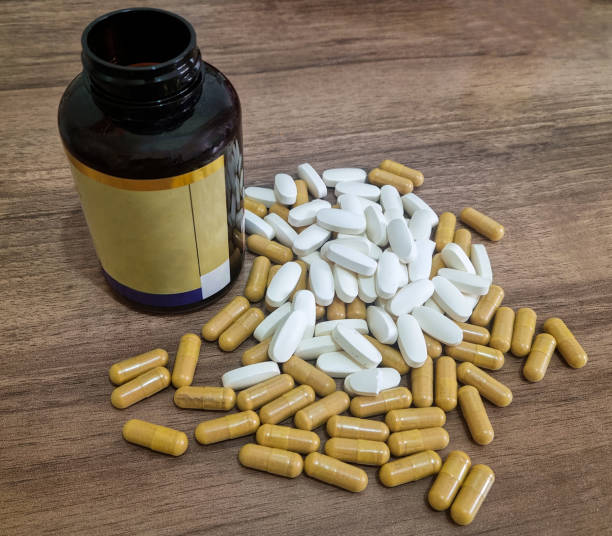 istock Medications pill on a wooden background 2196012279