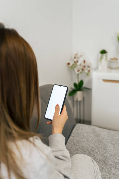 istock Woman Resting with Smartphone at Home 2196013995