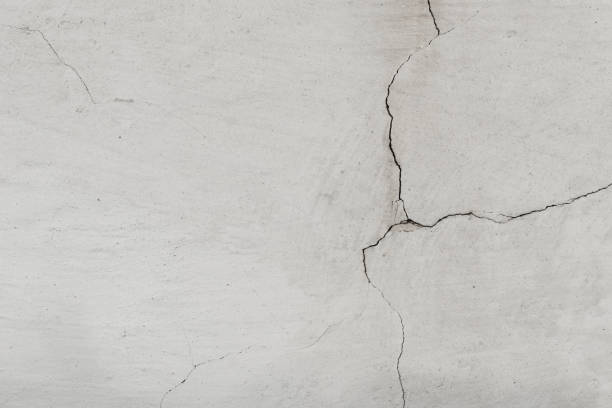 istock Grunge cracked concrete wall. Old wall with white plaster and cracked peeling texture in black and white tone copy space. Grungy wide brickwall. 2196014970