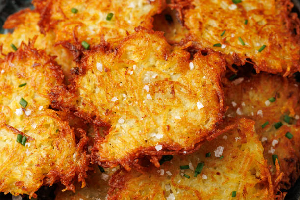 istock Crispy potato pancakes or latkes in a plate with herbs. 2196015775