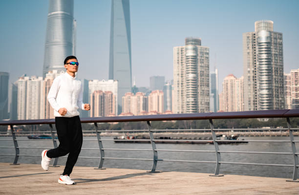 istock Young Asian man running outdoors in the city 2196017640