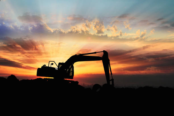 istock Crawler excavator  silhouette are digging the soil in the construction site 2196017765