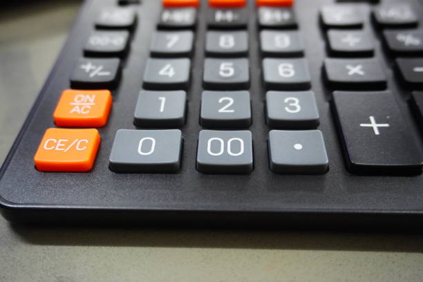 Close up calculator on business working desk, dark background.