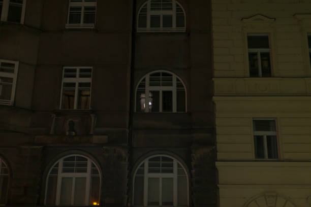 istock Dimly Lit Window Reflection in Urban Apartment Building at Night 2196018407