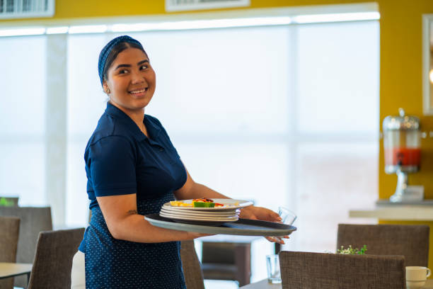istock Waitress prepares the table and arranges everything to wait for the arrival of the diners 2196020739