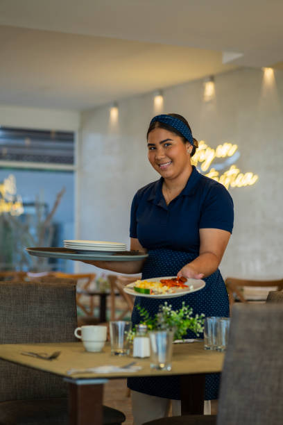 istock Waitress prepares the table and arranges everything to wait for the arrival of the diners 2196020814