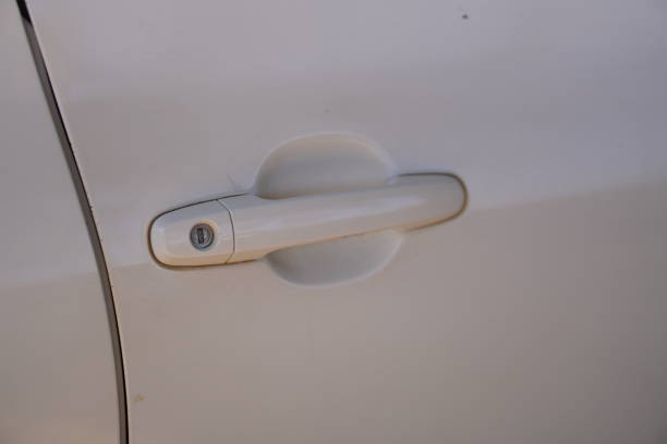istock White car door handle, closed car door 2196021249