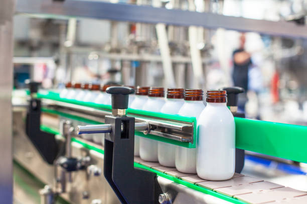 istock Automated assembly line for bottling and packaging liquid products in a modern industrial facility 2196021466