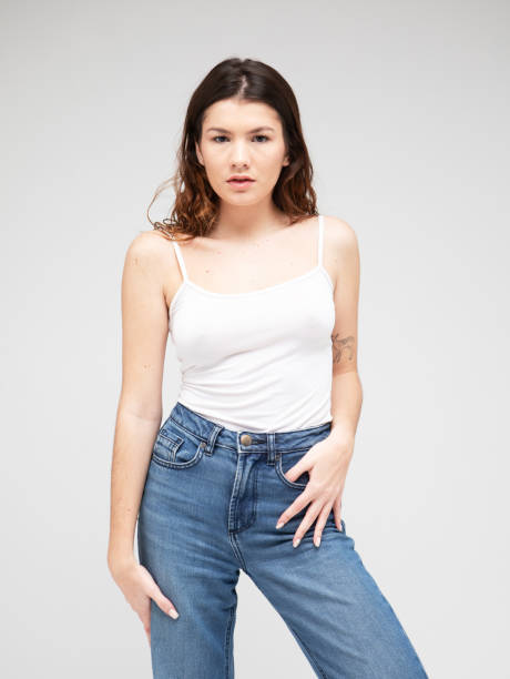 istock fashion model with long curly hair posing in studio over grey background 2196022043