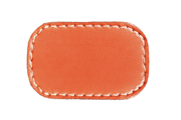 istock Brown leather belt strap closeup isolated on white. Brown stitched leather seam frame label tag isolated on white. 2196022658