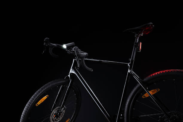istock Black gravel bicycle with illuminated light on dark background. 2196023574