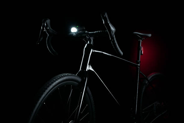 istock Black gravel bike with illuminated light on dark background 2196023595