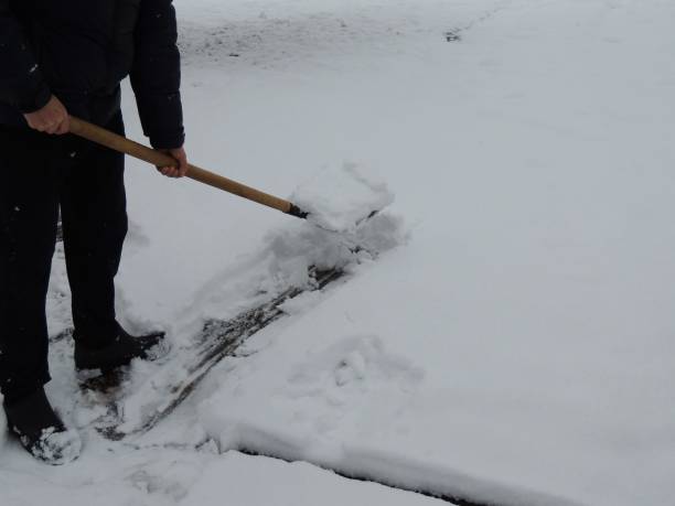 istock a person with a shovel making a path in fresh snowdrifts 2196025138