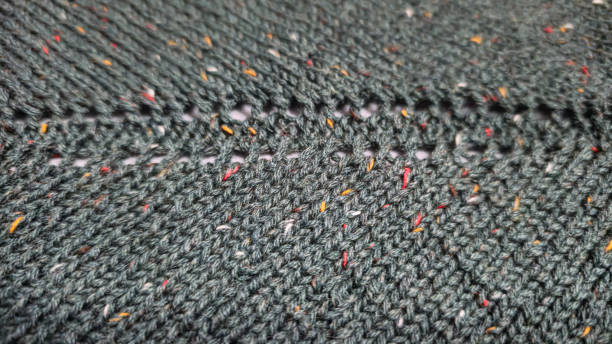 istock Knitted product from dark threads. Knitting a neck for a men's sweater. 2196025768
