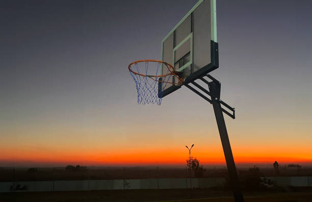 istock Basketball Hoop at Sunset in a Serene Landscape 2196025778