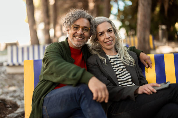 Free Stock Photo of Man and Woman Sitting on a Bench in Urban Park ...
