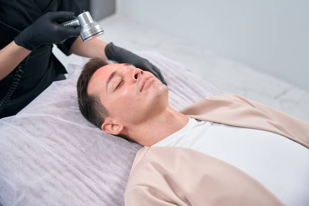istock Adult man visiting cosmetologist for red light therapy 2196029958