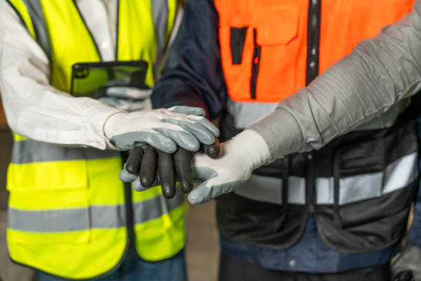 istock Professional engineer and technician wearing safety helmet analyzing meeting with tablet in factory warehouse. Confident factory workers group inspection industry factory. Teamwork concept. 2196030775