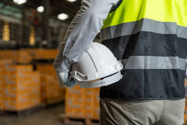 istock Close up technician engineer wearing and adjust protective safety helmet or hard hat. Safety equipment for industry factory. Safety at work concept. 2196030830