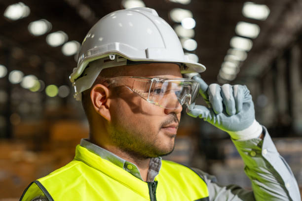 istock Close up technician engineer wearing and adjust protective safety glasses. Safety equipment for industry factory. Safety at work concept. 2196030831