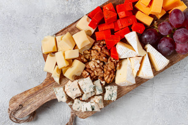 istock Assorted cheese on a wooden board, with grapes and walnuts, appetizer, no people. 2196033055