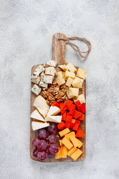 istock Assorted cheese on a wooden board, with grapes and walnuts, appetizer, no people. 2196033958