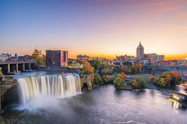 Rochester, New York, USA downtown skyline and waterfall from dusk till night.