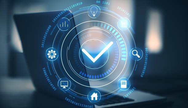 istock Neon checkmark icon in digital interface with futuristic design, displayed over a laptop background. 2196039229