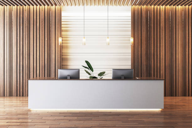 istock Modern reception desk with wood paneling and pendant lights in a corporate office space. 3D Rendering 2196039348
