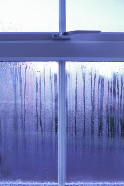 Condensation on a modern domestic plastic window forming after a cold night and a warm centrally heated bedroom
