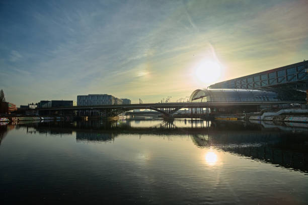 istock Berlin central station reflections on calm river under bright sunlight and open urban sky 2196043349