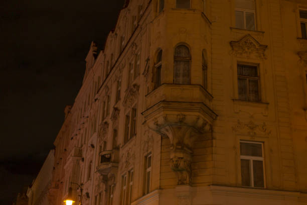A historic buildings stunning facade is illuminated at night, showcasing its intricate details