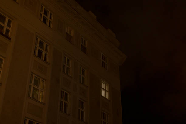 istock A Dark Building Facade with a Brightly Illuminated Window at Night 2196045213