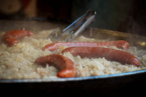 cooking sauerkraut with sausages, street restaurant in Trento, Italy