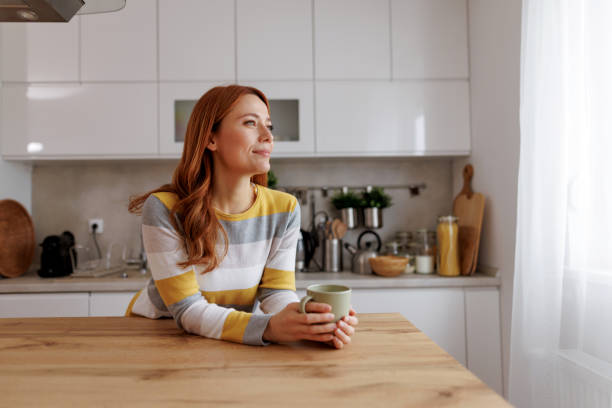 istock Woman relaxing with a cup of coffee in her modern kitchen 2196048761