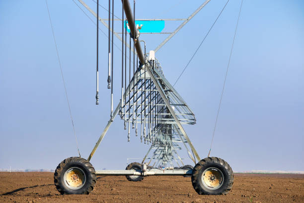 Center pivot crop irrigation system on field agricultural machinery