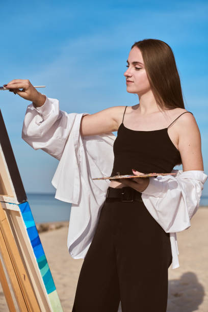 istock Young female painter creating art outdoors on sunny day 2196051131