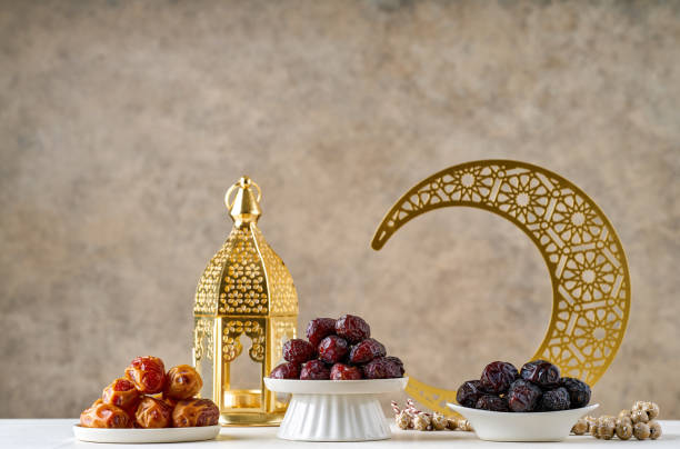istock Ramadan kareem background . Ramadan moon decor with Islamic prayer beads, lantern fanous and various type of dates fruit. 2196052745