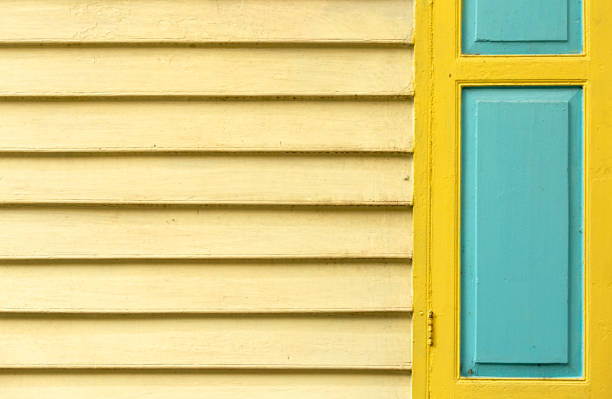 istock two-tone window on pastel ocher slats 2196054923