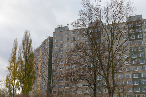 istock A tall building stands prominently with trees in front on a cloudy day 2196055329