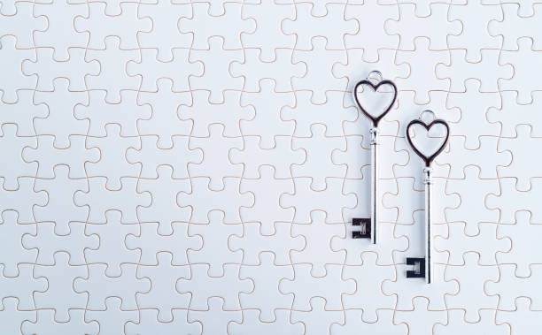 istock Two heart shaped antique keys on the white puzzle background 2196056421