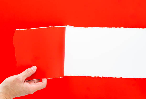 istock Hand tearing a red paper on white background 2196056505