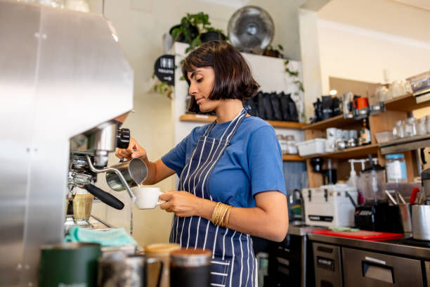 istock Barista making a cappuccino at a coffee shop 2196056522