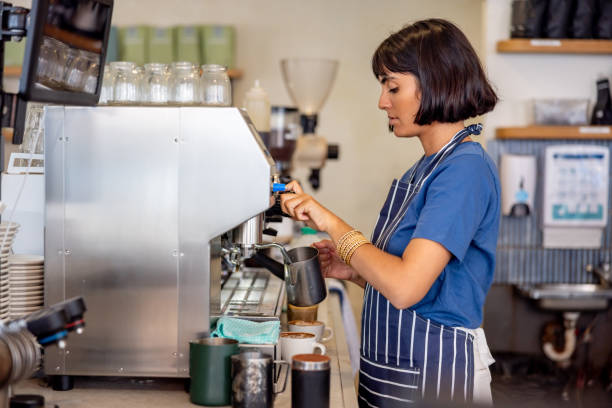 istock Barista making an espresso using a coffee maker at a cafe 2196056527